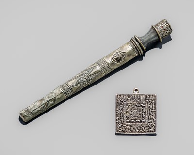 A SILVERED REPOUSSÉ DAGGER AND PLAQUE, TIBET, 19TH TO EARLY 20TH CENTURY