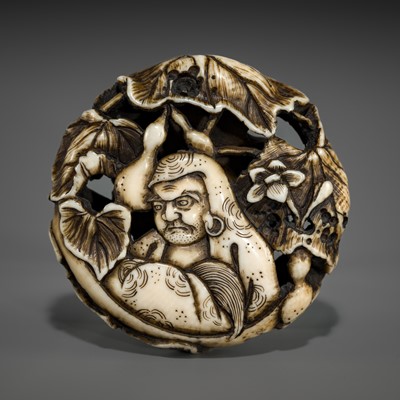 Lot 548 - BUNZAN: A FINE WALRUS TUSK RYUSA MANJU NETSUKE WITH DARUMA AND HYOTAN