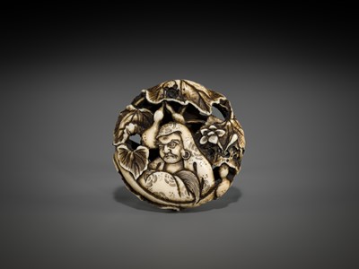 Lot 548 - BUNZAN: A FINE WALRUS TUSK RYUSA MANJU NETSUKE WITH DARUMA AND HYOTAN