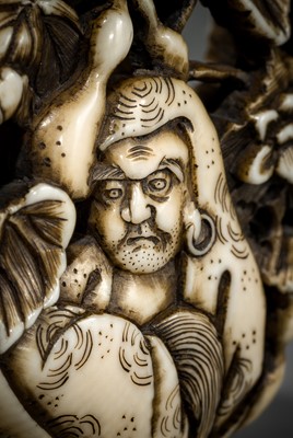 Lot 548 - BUNZAN: A FINE WALRUS TUSK RYUSA MANJU NETSUKE WITH DARUMA AND HYOTAN