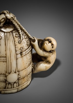 Lot 124 - A FINE KYOTO SCHOOL IVORY NETSUKE OF A MONKEY SCALING A TEMPLE BELL (BONSHO)