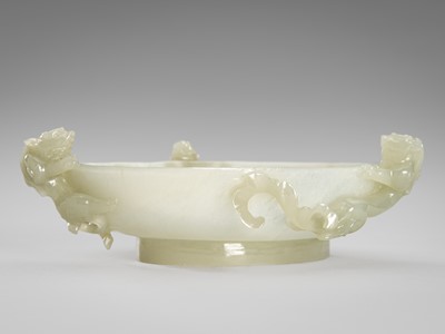 Lot 960 - A PALE CELADON JADE BOWL WITH THREE DRAGONS, QING DYNASTY