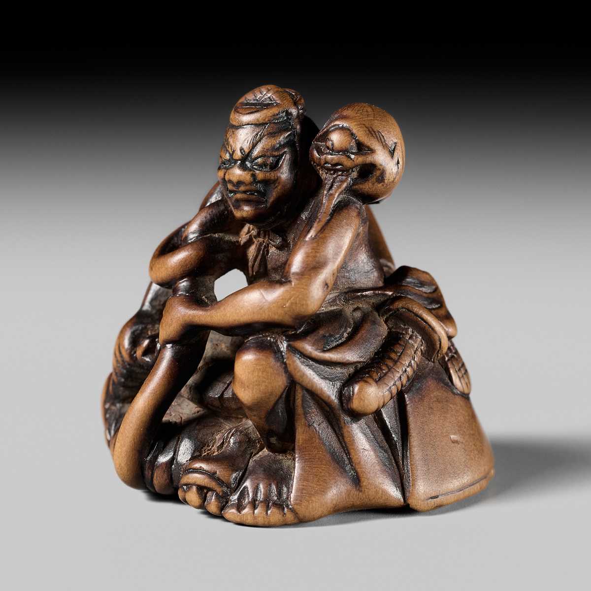 Lot 440 - KOKUZAN: A RARE WOOD NETSUKE DEPICTING A WARRIOR STRUGGLING WITH A YOKAI