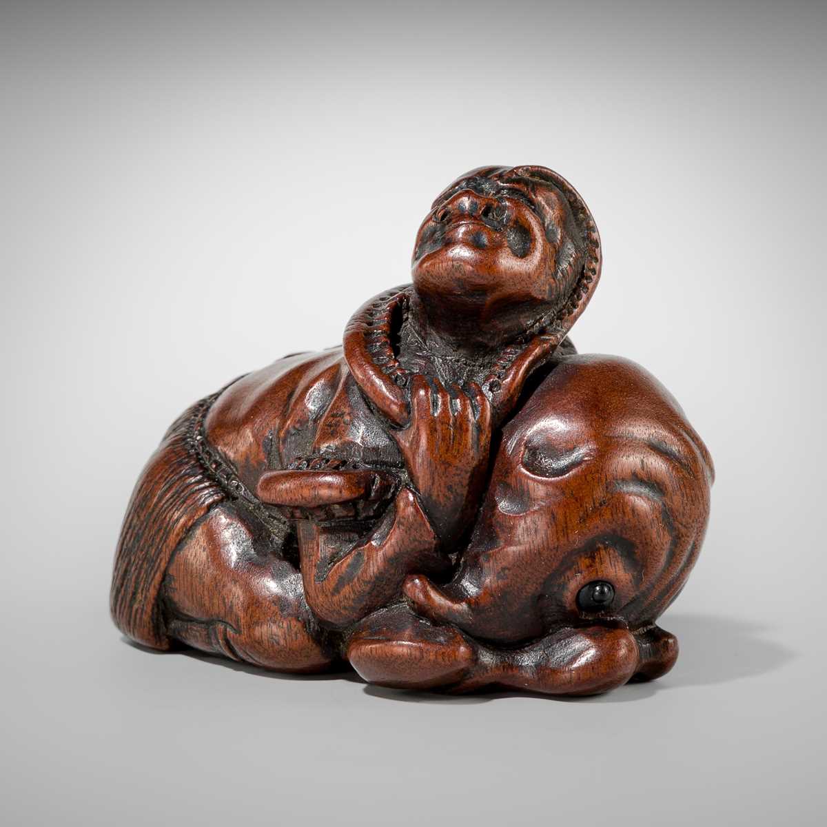 Lot 434 - A FINE EDO SCHOOL WOOD NETSUKE OF ARIOMARU STRUGGLING WITH AN OCTOPUS