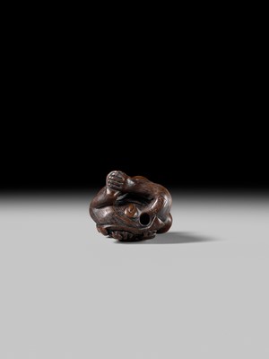 SUKEYUKI: A FINE WOOD NETSUKE OF A PERFORMING MONKEY