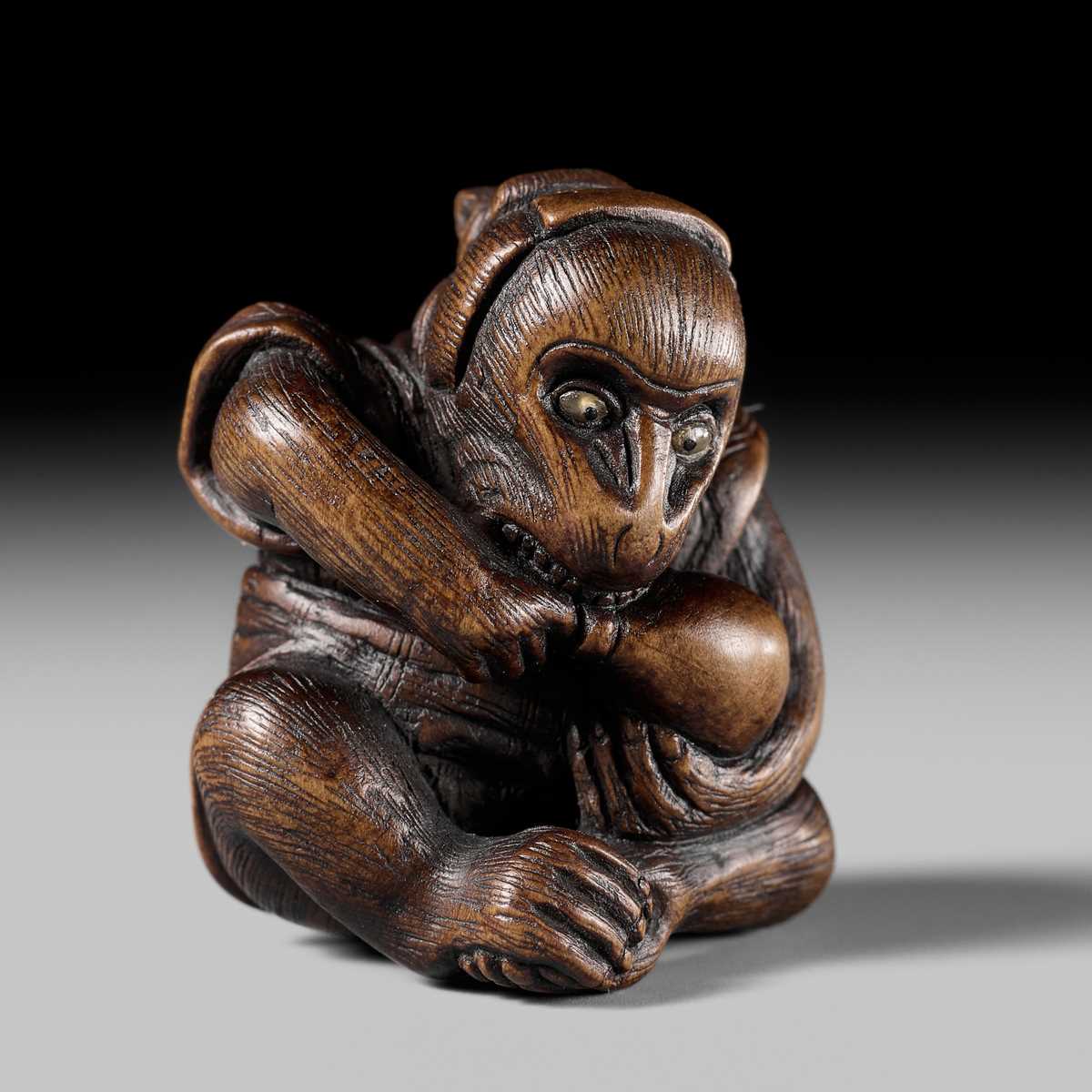 SUKEYUKI: A FINE WOOD NETSUKE OF A PERFORMING MONKEY