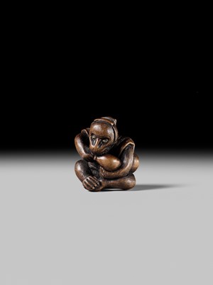 SUKEYUKI: A FINE WOOD NETSUKE OF A PERFORMING MONKEY