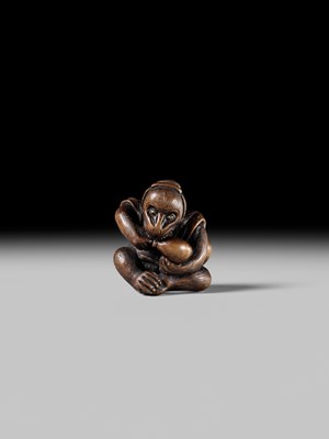 SUKEYUKI: A FINE WOOD NETSUKE OF A PERFORMING MONKEY
