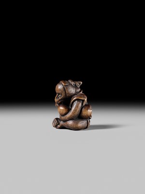 SUKEYUKI: A FINE WOOD NETSUKE OF A PERFORMING MONKEY