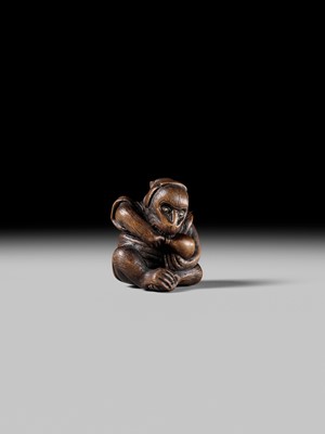 SUKEYUKI: A FINE WOOD NETSUKE OF A PERFORMING MONKEY