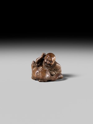 Lot 441 - YOSHIHIDE: A VERY FINE WOOD NETSUKE OF A PRIEST STARTLED BY A TANUKI KETTLE