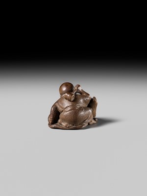 Lot 441 - YOSHIHIDE: A VERY FINE WOOD NETSUKE OF A PRIEST STARTLED BY A TANUKI KETTLE