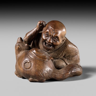 Lot 441 - YOSHIHIDE: A VERY FINE WOOD NETSUKE OF A PRIEST STARTLED BY A TANUKI KETTLE
