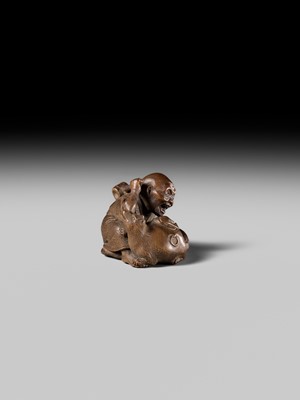 Lot 441 - YOSHIHIDE: A VERY FINE WOOD NETSUKE OF A PRIEST STARTLED BY A TANUKI KETTLE