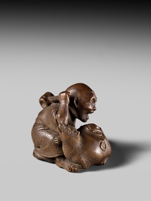 Lot 441 - YOSHIHIDE: A VERY FINE WOOD NETSUKE OF A PRIEST STARTLED BY A TANUKI KETTLE