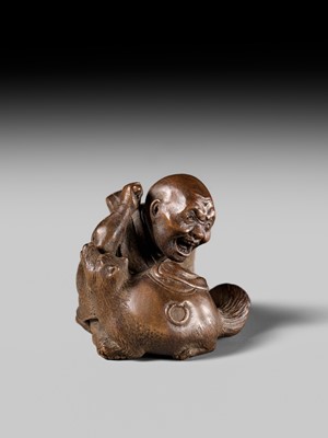 Lot 441 - YOSHIHIDE: A VERY FINE WOOD NETSUKE OF A PRIEST STARTLED BY A TANUKI KETTLE