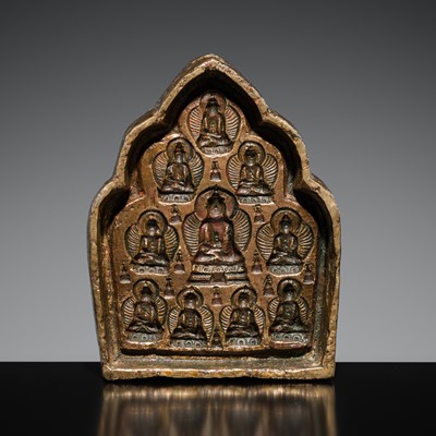 Lot 254 - A BRONZE TSA-TSA ‘AKSHOBHYA BUDDHA’ MOLD, TIBET, c. 17TH CENTURY