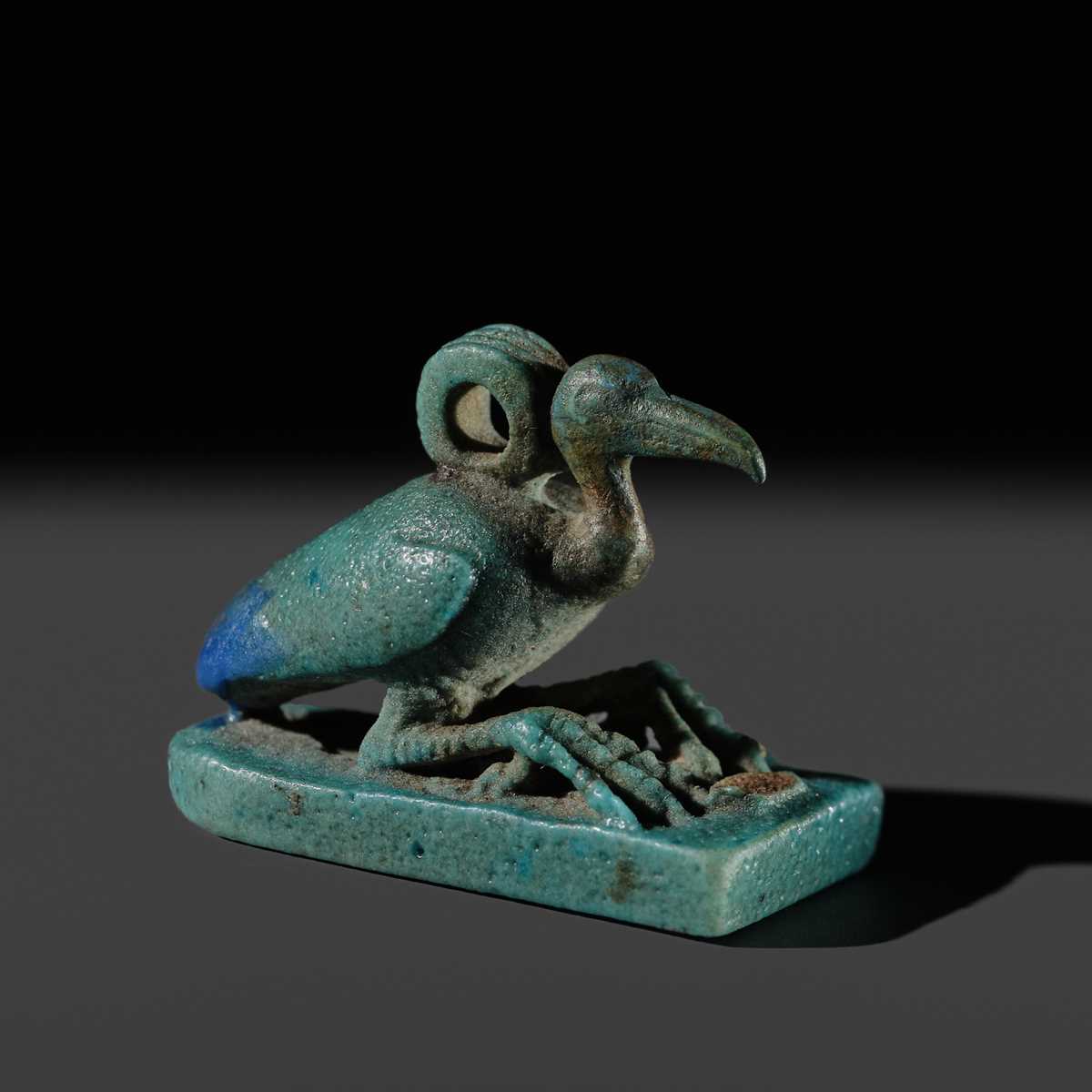 Lot 51 - AN ‘IBIS’ AMULET, BLUE AND GREEN BICHROME FAIENCE, LATE PERIOD, DYNASTY XXV-XXXI