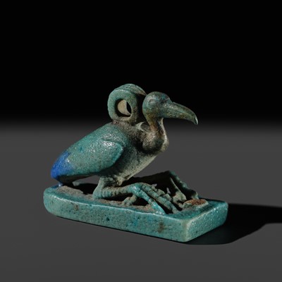 AN ‘IBIS’ AMULET, BLUE AND GREEN BICHROME FAIENCE, LATE PERIOD, DYNASTY XXV-XXXI