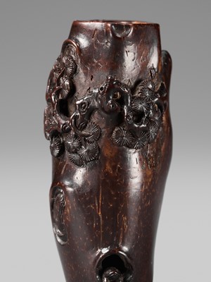 AN UNUSUAL AND RARE COCONUT NETSUKE OF MONKEYS AND A TOAD ON A PINE TREE