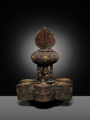 Lot 11 - A PARCEL-GILT COPPER REPOUSSÉ BUDDHIST RITUAL CONTAINER, NEPAL, 16TH-17TH CENTURY