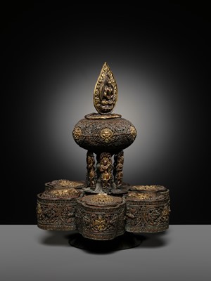 Lot 11 - A PARCEL-GILT COPPER REPOUSSÉ BUDDHIST RITUAL CONTAINER, NEPAL, 16TH-17TH CENTURY