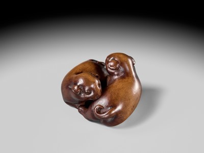 A WOOD NETSUKE OF TWO PUPPIES AT PLAY, ATTRIBUTED TO MASANAO OF KYOTO
