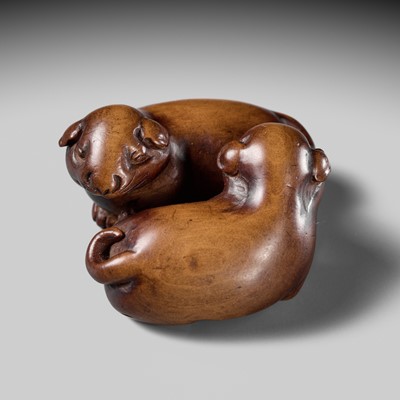 A WOOD NETSUKE OF TWO PUPPIES AT PLAY, ATTRIBUTED TO MASANAO OF KYOTO