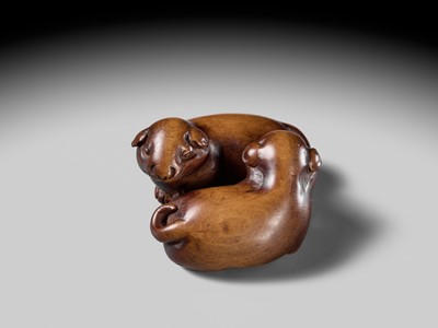 A WOOD NETSUKE OF TWO PUPPIES AT PLAY, ATTRIBUTED TO MASANAO OF KYOTO