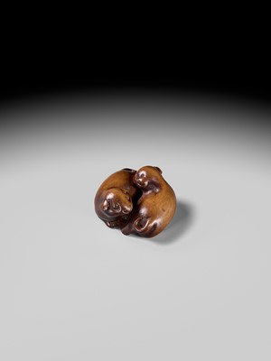 A WOOD NETSUKE OF TWO PUPPIES AT PLAY, ATTRIBUTED TO MASANAO OF KYOTO