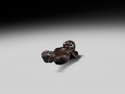 A TALL WOOD NETSUKE OF A MAN TYING HIS FUNDOSHI (LOINCLOTH), ATTRIBUTED TO AWATAGUCHI