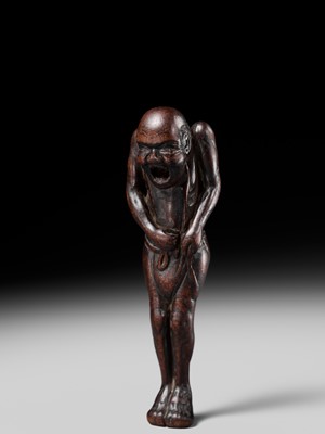 A TALL WOOD NETSUKE OF A MAN TYING HIS FUNDOSHI (LOINCLOTH), ATTRIBUTED TO AWATAGUCHI
