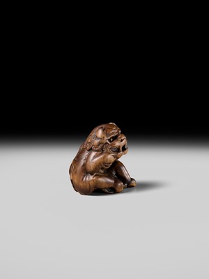 A POWERFUL HINOKI WOOD NETSUKE OF A SHISHIMAI DANCER
