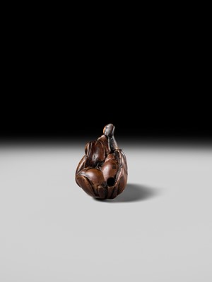 A POWERFUL HINOKI WOOD NETSUKE OF A SHISHIMAI DANCER