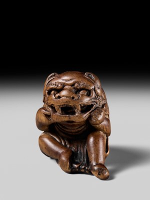 A POWERFUL HINOKI WOOD NETSUKE OF A SHISHIMAI DANCER