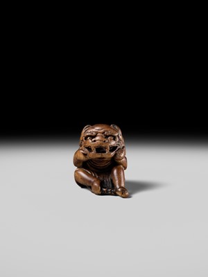 A POWERFUL HINOKI WOOD NETSUKE OF A SHISHIMAI DANCER