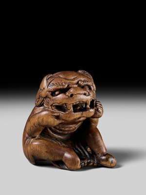 A POWERFUL HINOKI WOOD NETSUKE OF A SHISHIMAI DANCER