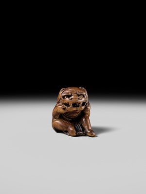 A POWERFUL HINOKI WOOD NETSUKE OF A SHISHIMAI DANCER