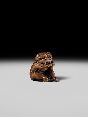 A POWERFUL HINOKI WOOD NETSUKE OF A SHISHIMAI DANCER