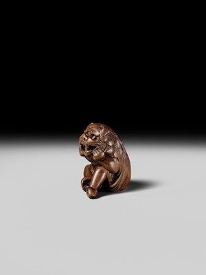 A POWERFUL HINOKI WOOD NETSUKE OF A SHISHIMAI DANCER