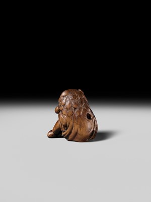 A POWERFUL HINOKI WOOD NETSUKE OF A SHISHIMAI DANCER
