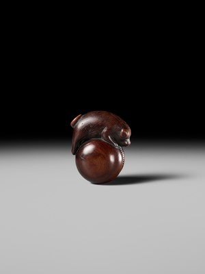 A FINE KYOTO SCHOOL WOOD NETSUKE OF A PUPPY BALANCING ON A KEMARI BALL, ATTRIBUTED TO OKATOMO