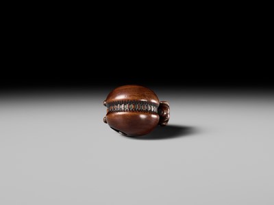 A FINE KYOTO SCHOOL WOOD NETSUKE OF A PUPPY BALANCING ON A KEMARI BALL, ATTRIBUTED TO OKATOMO