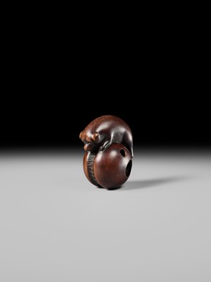A FINE KYOTO SCHOOL WOOD NETSUKE OF A PUPPY BALANCING ON A KEMARI BALL, ATTRIBUTED TO OKATOMO