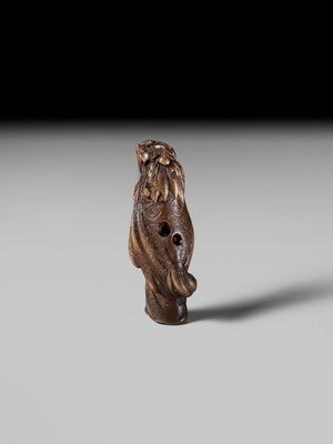 A LARGE HINOKI WOOD NETSUKE OF A SHISHIMAI DANCER