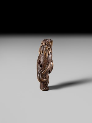 A LARGE HINOKI WOOD NETSUKE OF A SHISHIMAI DANCER