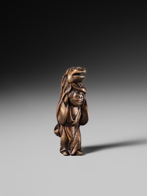 A LARGE HINOKI WOOD NETSUKE OF A SHISHIMAI DANCER