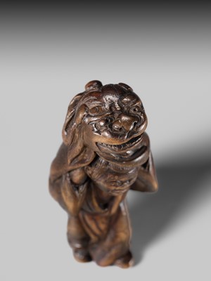 A LARGE HINOKI WOOD NETSUKE OF A SHISHIMAI DANCER