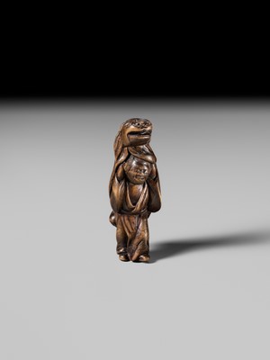 A LARGE HINOKI WOOD NETSUKE OF A SHISHIMAI DANCER