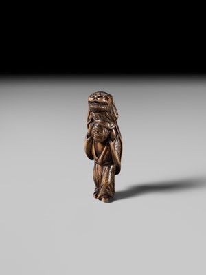 A LARGE HINOKI WOOD NETSUKE OF A SHISHIMAI DANCER